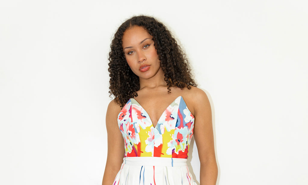 model posing posing against neutral background in Eva Multicolor Splash Floral V-Bustier Knee-Length Dress