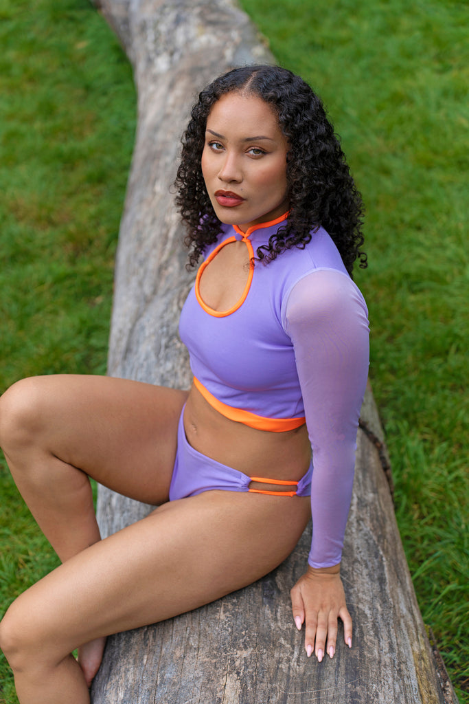 model posing lilac and orange long sleeve mesh swimsuit